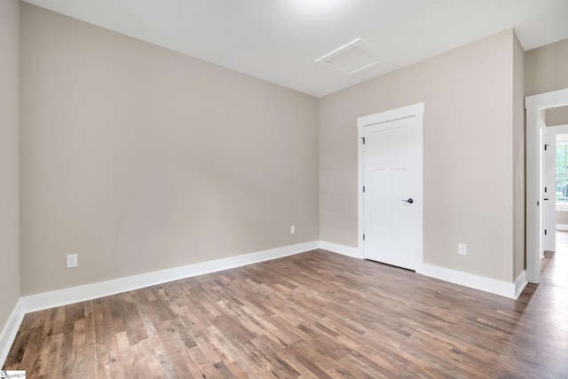 spare room with hardwood / wood-style flooring