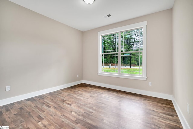 unfurnished room with wood-type flooring