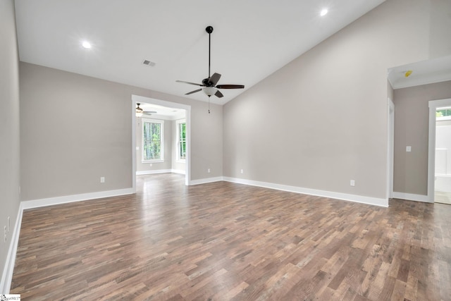 unfurnished living room with vaulted ceiling, ceiling fan, and dark wood-type flooring