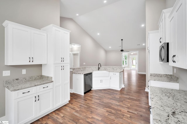 kitchen with light stone countertops, white cabinetry, dark hardwood / wood-style flooring, and stainless steel appliances