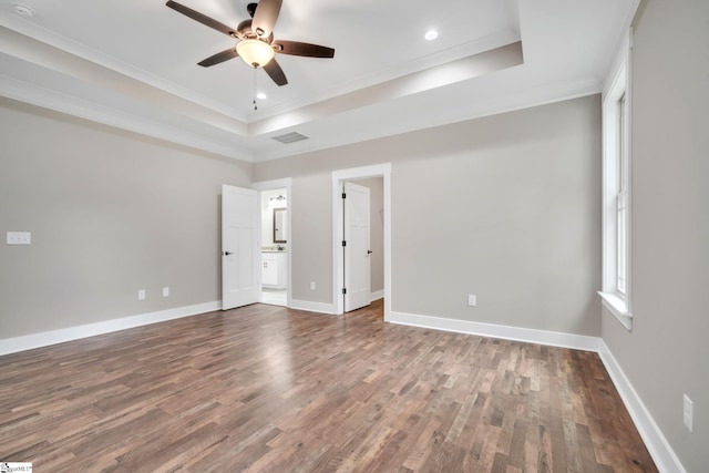 spare room with wood-type flooring, a tray ceiling, ceiling fan, and crown molding