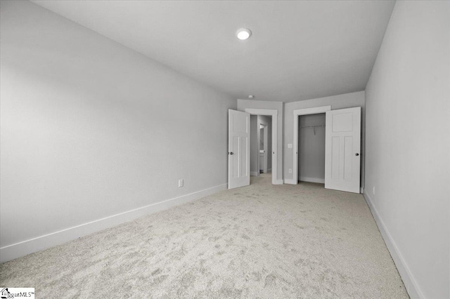 unfurnished bedroom with carpet floors and a closet