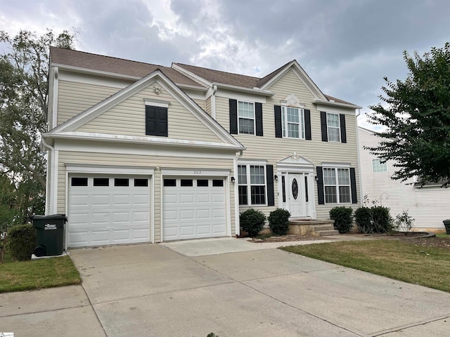 view of front of property with a front lawn and a garage