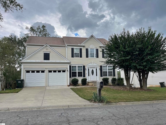 view of front of house featuring a garage and a front lawn