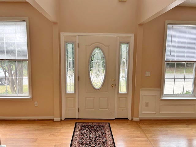 entrance foyer with plenty of natural light and light hardwood / wood-style flooring