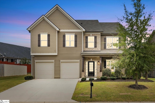 view of front of house featuring a garage and a yard