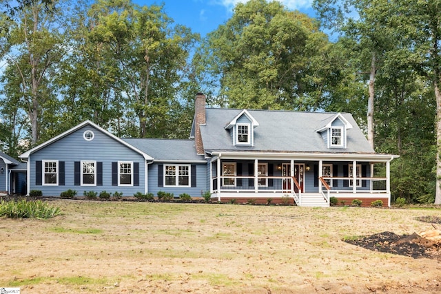 view of front facade featuring covered porch and a front yard