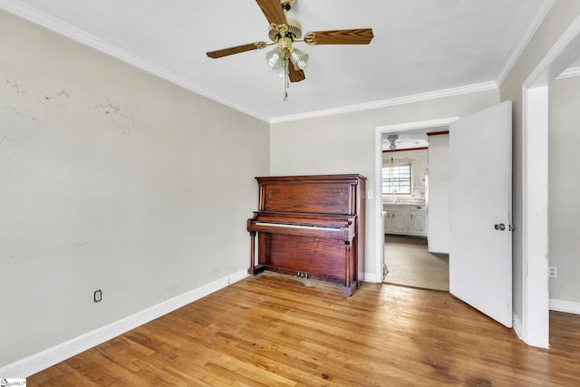 interior space featuring light hardwood / wood-style floors, crown molding, and ceiling fan