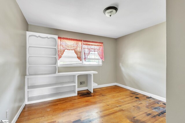 unfurnished office featuring hardwood / wood-style floors