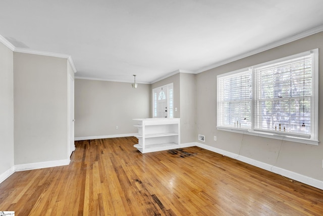 unfurnished living room with ornamental molding and light hardwood / wood-style floors