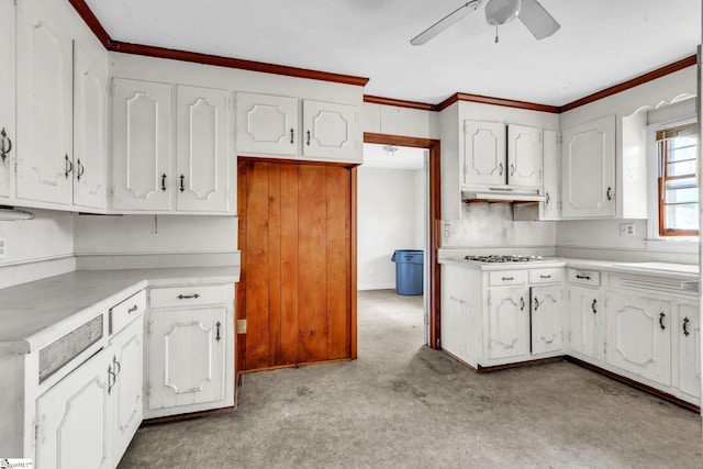 kitchen featuring ornamental molding, white cabinets, gas cooktop, and ceiling fan