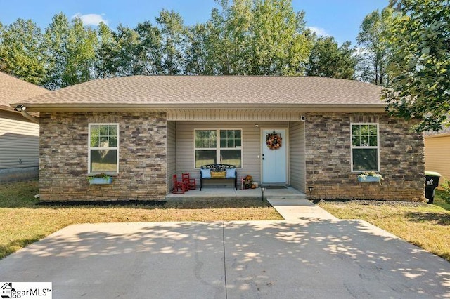 ranch-style house with a front yard and a porch