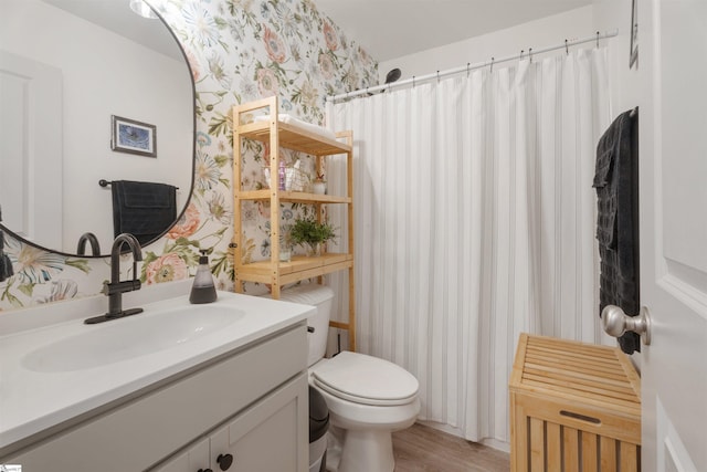 bathroom featuring a shower with curtain, hardwood / wood-style floors, vanity, and toilet