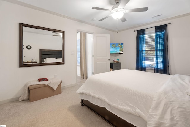 bedroom featuring ceiling fan, light carpet, and crown molding