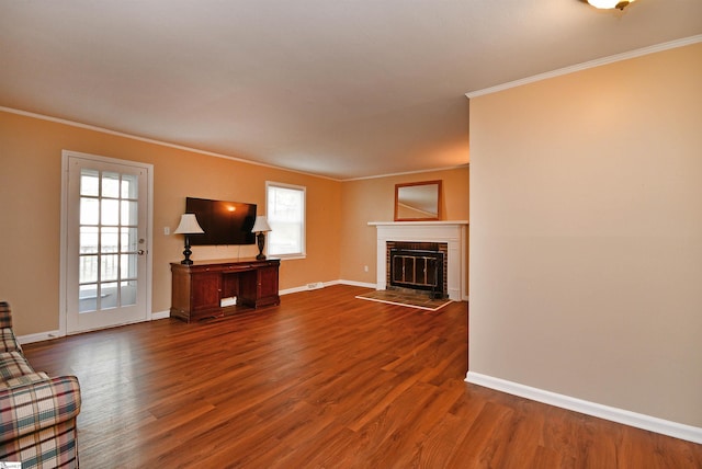 unfurnished living room featuring ornamental molding, a fireplace, and dark wood-type flooring