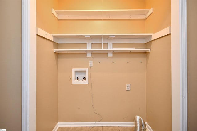 clothes washing area with hookup for a washing machine, hookup for an electric dryer, and tile patterned floors