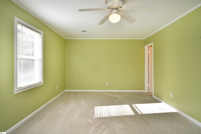 unfurnished room featuring light carpet, crown molding, and ceiling fan