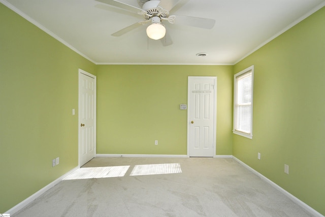 unfurnished room featuring ornamental molding and light colored carpet