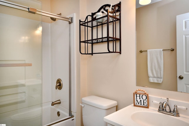 full bathroom with combined bath / shower with glass door, vanity, and toilet