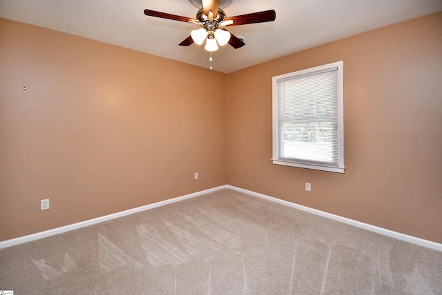 empty room featuring ceiling fan and carpet