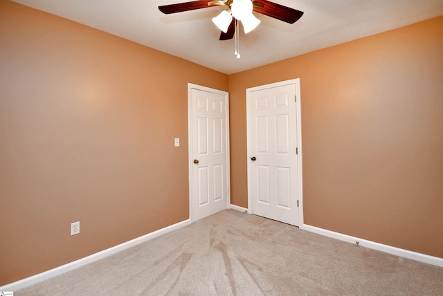 unfurnished room featuring ceiling fan and carpet flooring