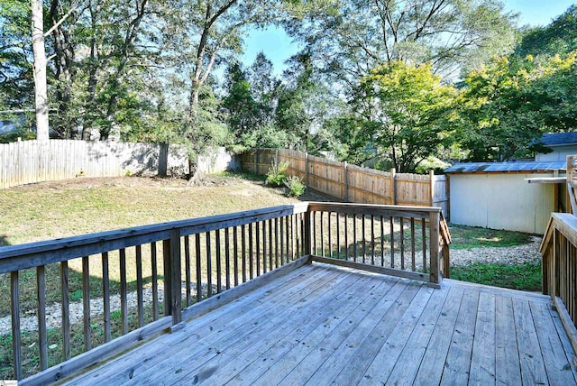 wooden deck with a yard and a shed