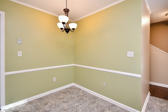 spare room featuring ornamental molding and an inviting chandelier