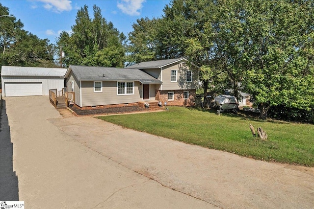 tri-level home featuring an outdoor structure, a garage, and a front lawn