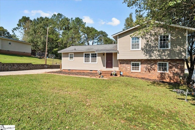 tri-level home with a front lawn