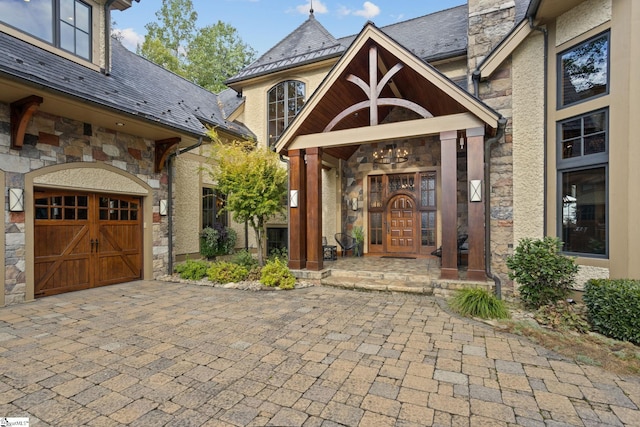 view of exterior entry with a garage