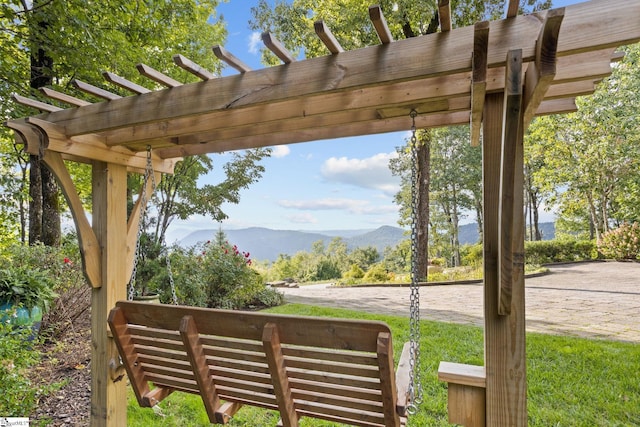 exterior space featuring a mountain view and a pergola