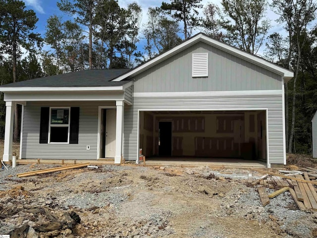 view of front of house featuring covered porch and a garage