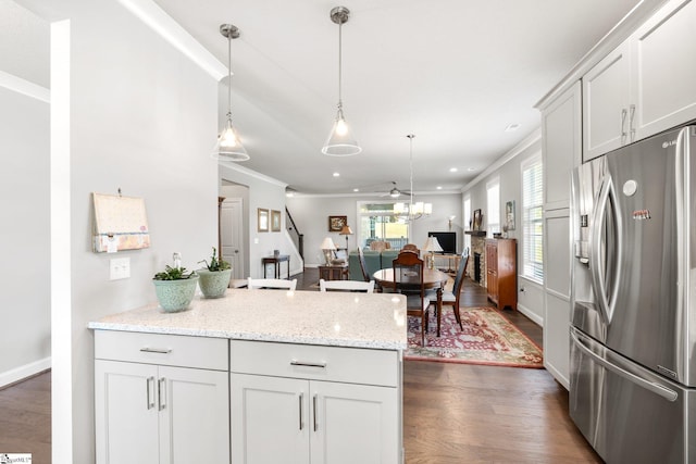 kitchen with stainless steel fridge with ice dispenser, dark wood-type flooring, and white cabinets