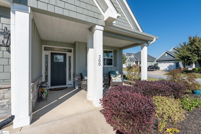 property entrance featuring a garage and a porch