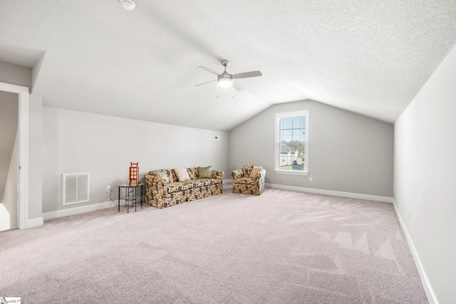 bonus room featuring light colored carpet, vaulted ceiling, a textured ceiling, and ceiling fan