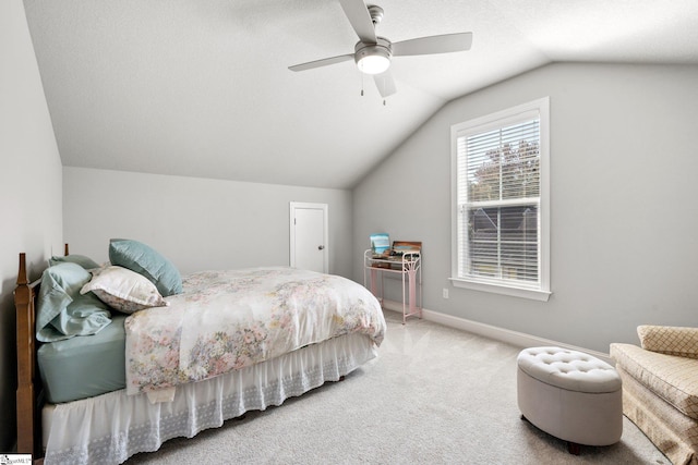 carpeted bedroom with lofted ceiling, a textured ceiling, and ceiling fan