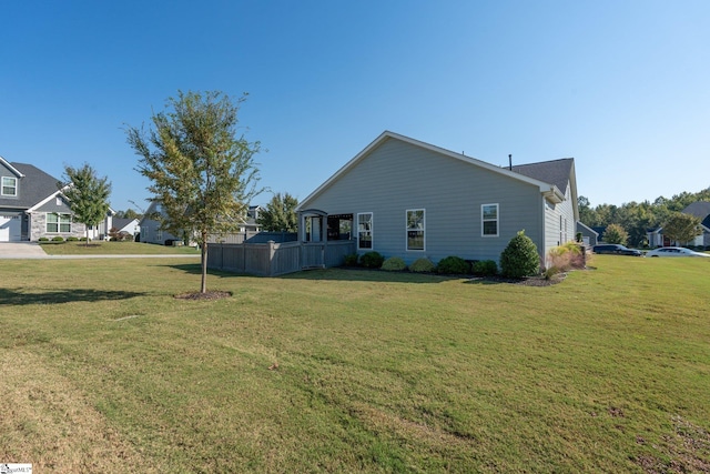 view of side of home with a lawn