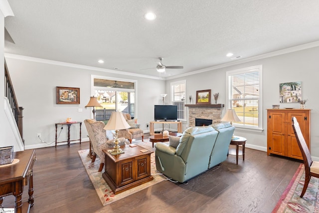 living room featuring ornamental molding, a textured ceiling, plenty of natural light, and dark wood-type flooring