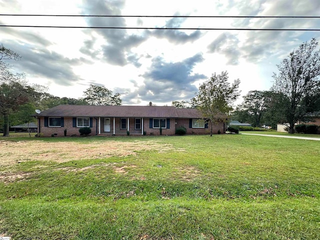 ranch-style home featuring a front yard