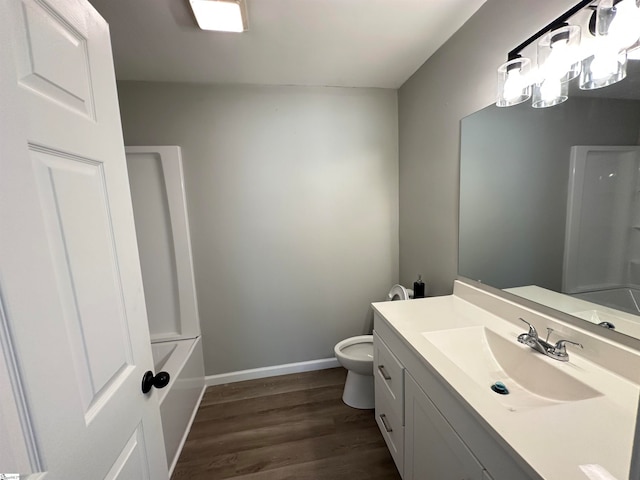 bathroom featuring hardwood / wood-style floors, vanity, and toilet