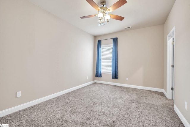 carpeted spare room with ceiling fan