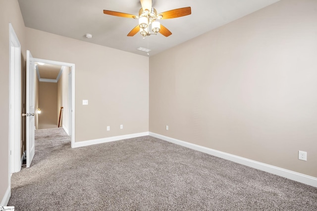 carpeted spare room featuring ceiling fan