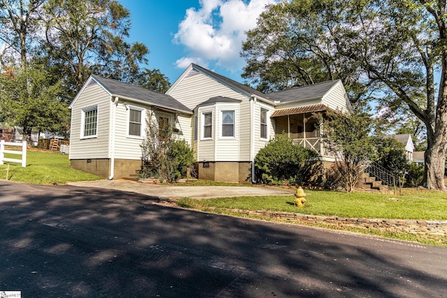 bungalow-style house featuring a front yard