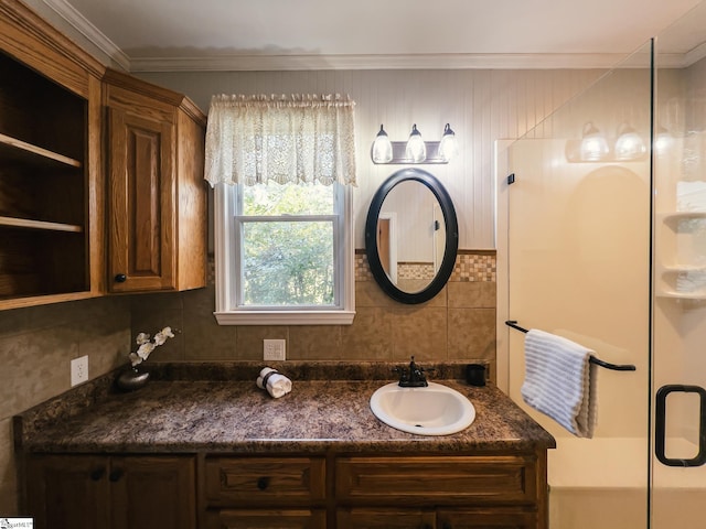 bathroom with tasteful backsplash, ornamental molding, a shower with door, and vanity