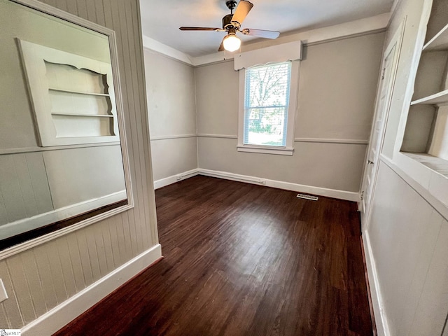 empty room featuring ceiling fan and dark hardwood / wood-style floors