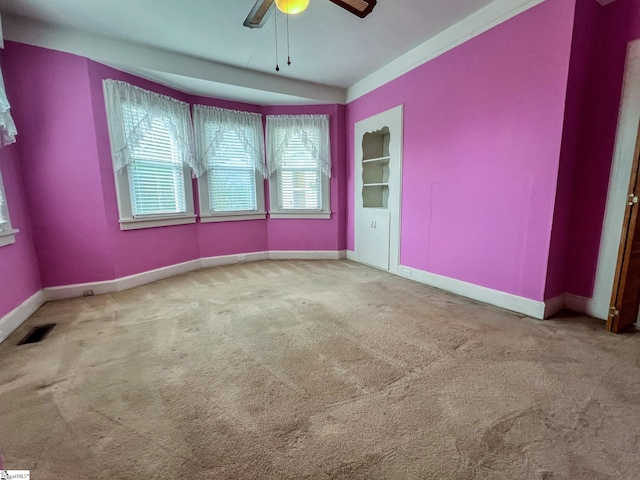 carpeted spare room with ceiling fan