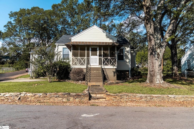 bungalow-style home featuring a front lawn