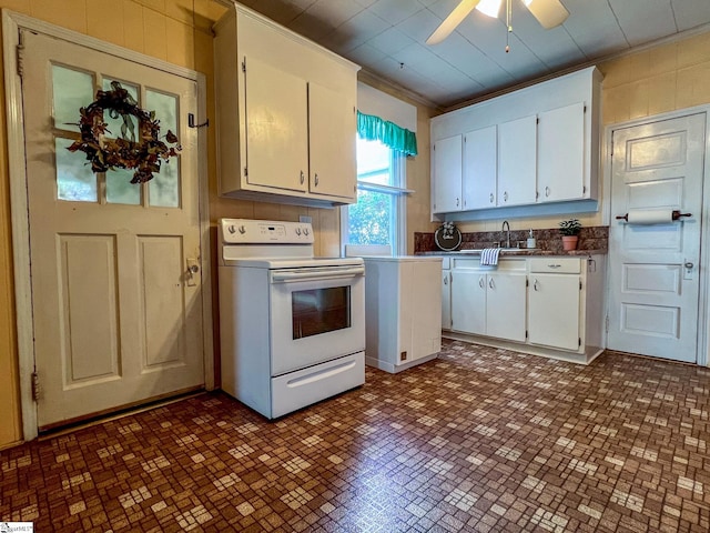 kitchen with ceiling fan, white electric range oven, ornamental molding, and white cabinetry