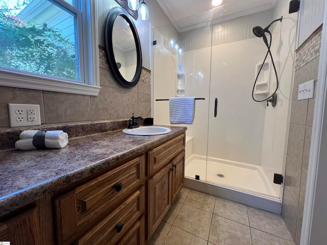 bathroom with vanity, a shower with shower door, crown molding, and tile patterned floors