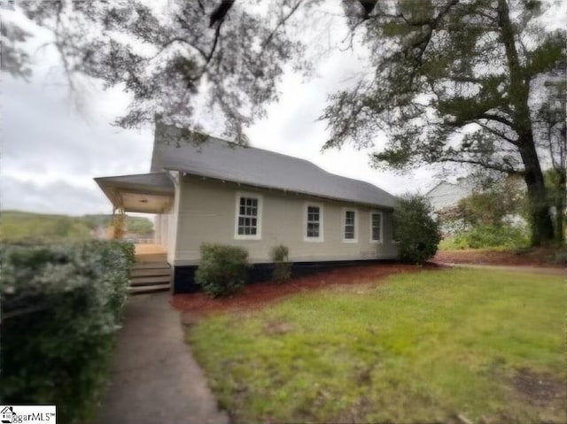 rear view of house with a yard